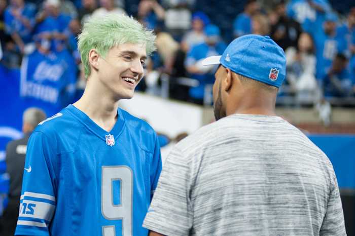 Popular streamer Tyler Blevins aka Ninja talks to a Lions player before a game